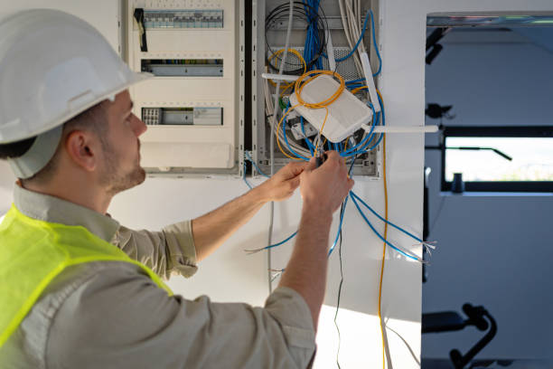 Young male Caucasian electrician working on the electrical installation of a new house, he is focused and dedicated to his workYoung male Caucasian electrician working on the electrical installation of a new house, he is focused and dedicated to his work